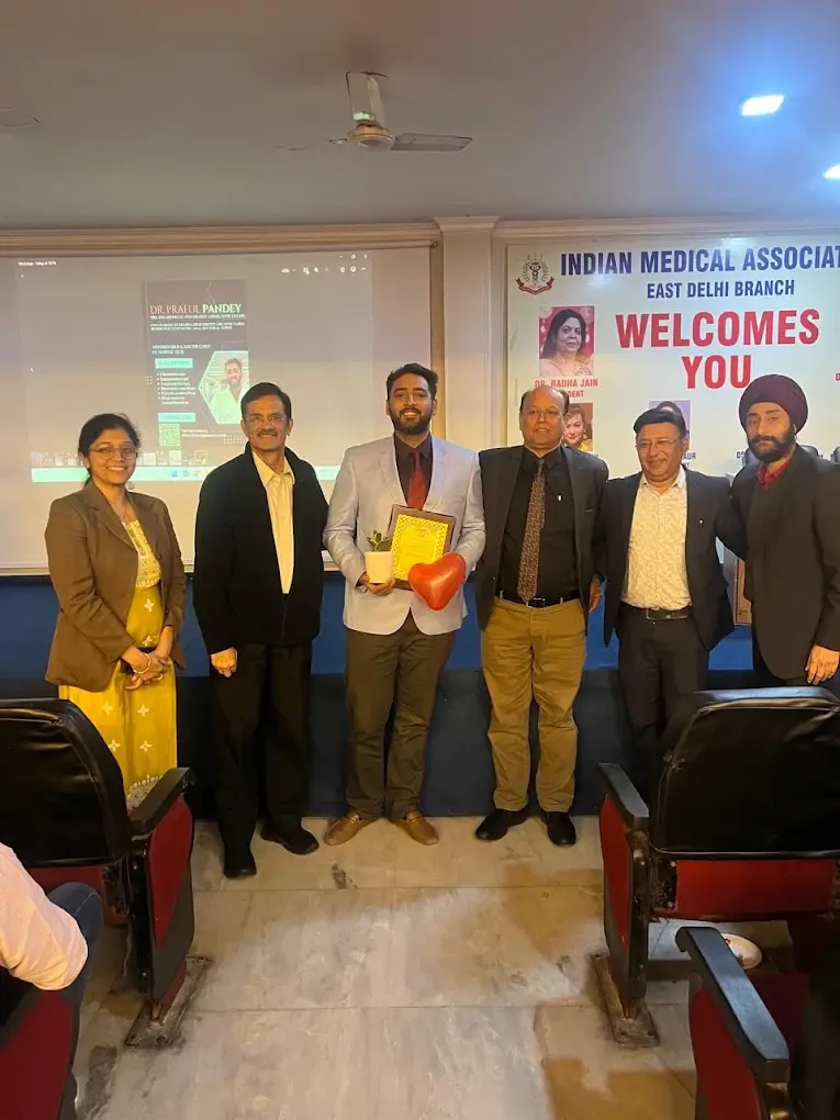 Dr. Praful Pandey receiving recognition after an academic presentation